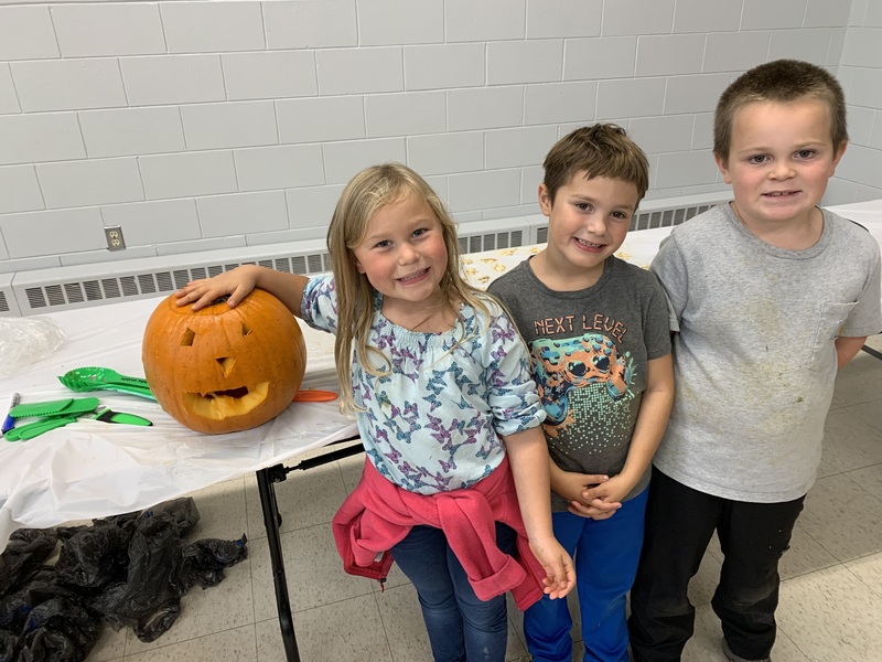 Students with jack o’ lanterns.