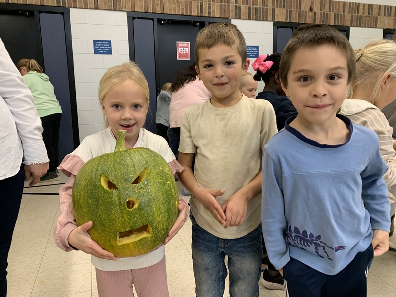 Students with jack o’ lanterns.