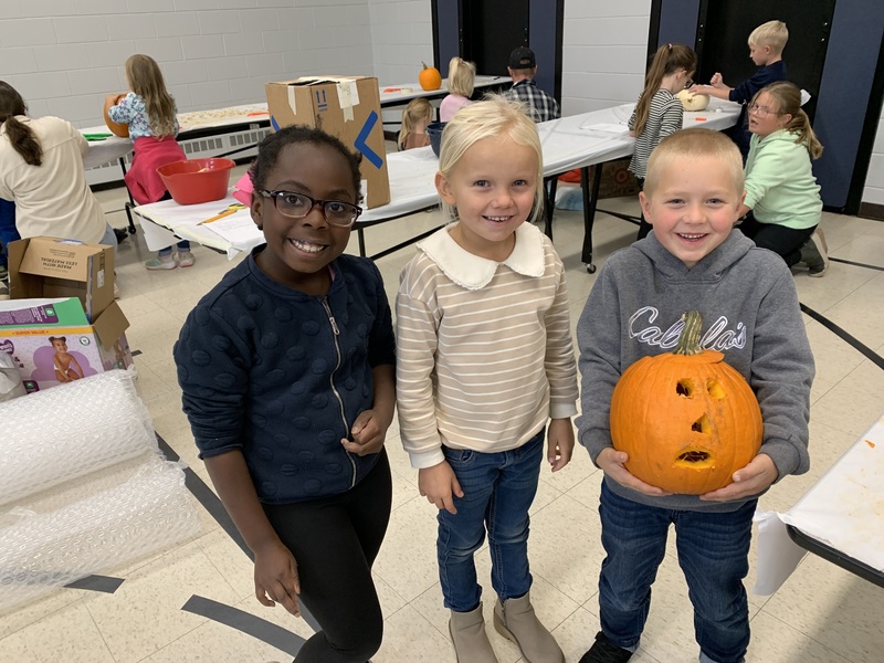 Students with jack o’ lanterns.
