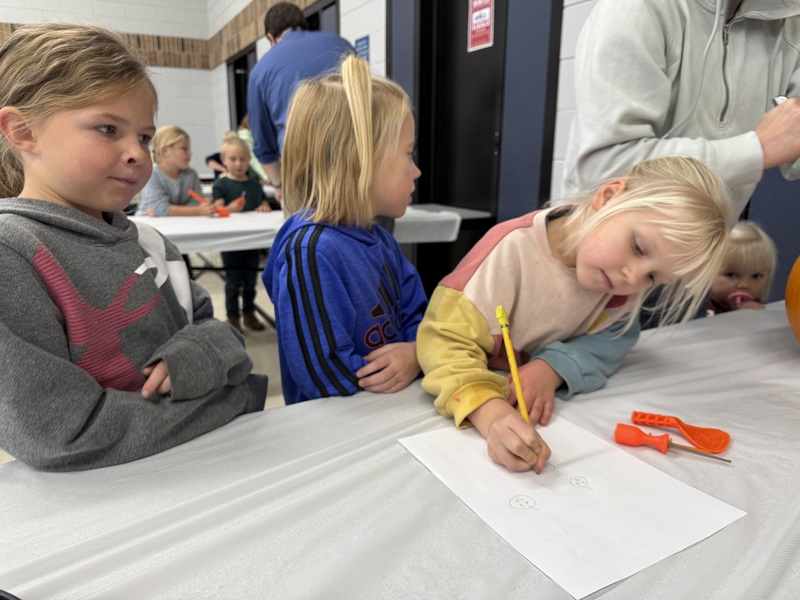 Student designing pumpkin.