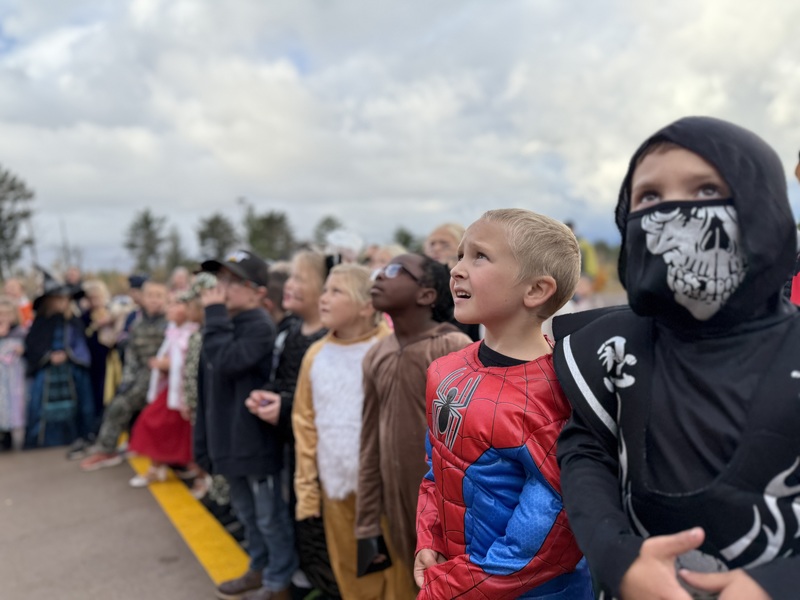 Kids watching pumpkin drop.