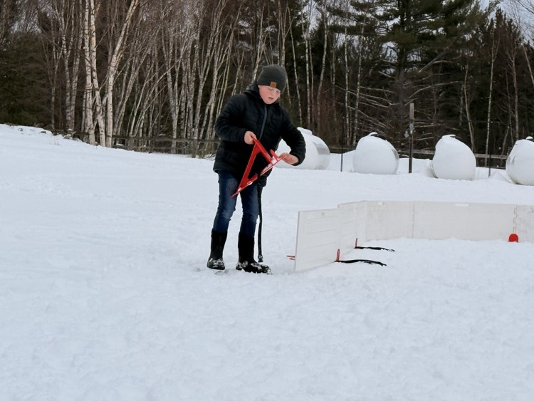 5th grader sets wall pieces.