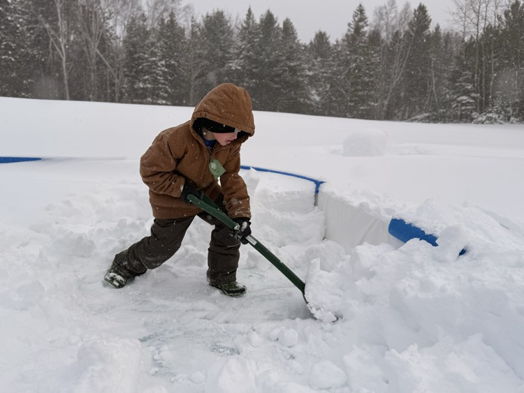 student shoveling snow