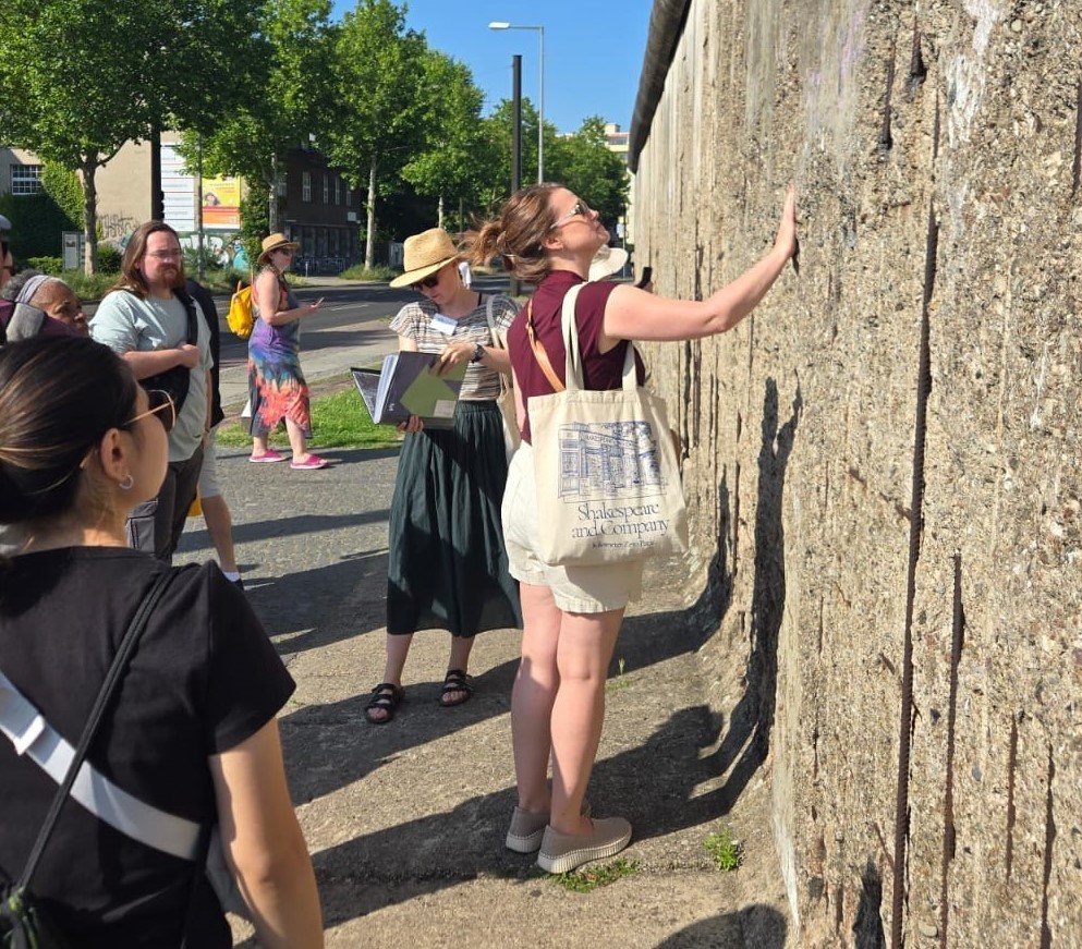 woman examining the Berlin Wall