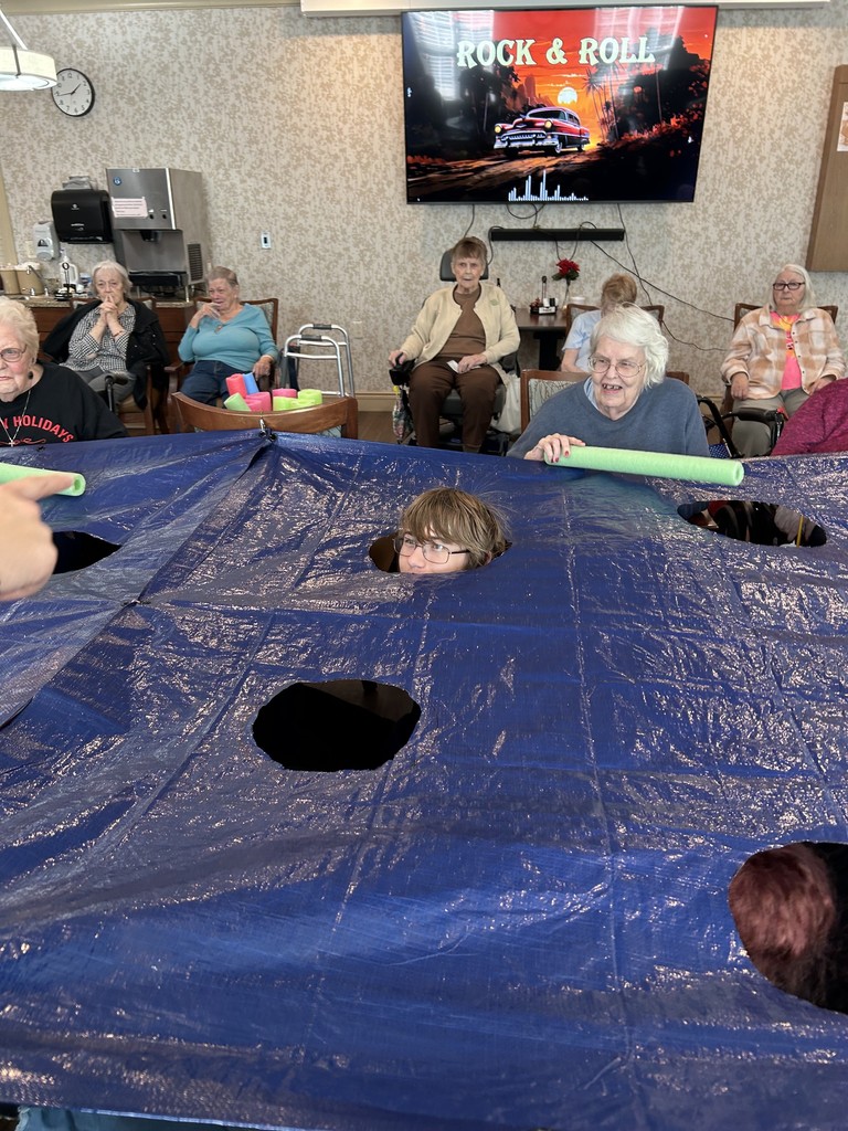 Students hiding before coming out of tarp to be Wacked by a resident.