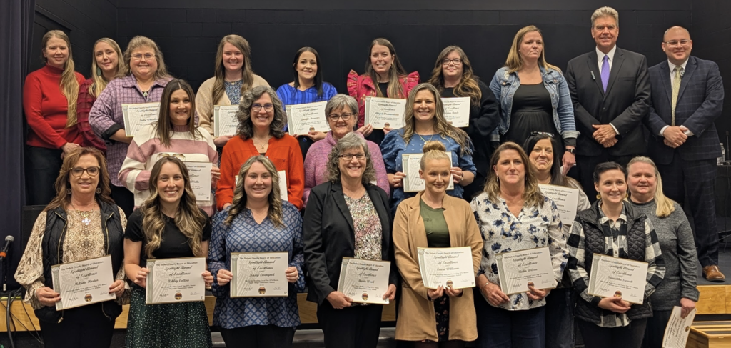 Some the teachers who earned the bonus with the BOE members. 