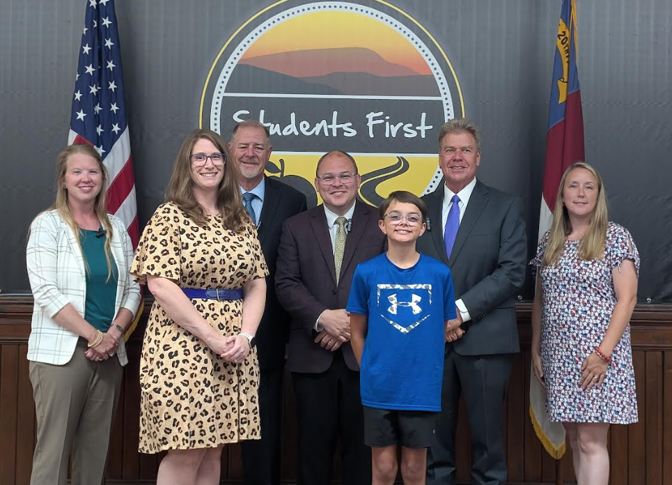 Hollis and teacher with school board members