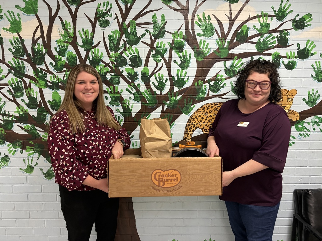 Ms. Block, Assistant Principal receiving biscuits & gravy from Alexandria Kendrick, Local Marketing Coordinator, Cracker Barrel