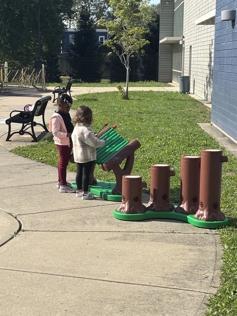 Students making music at our new outdoor drum and chime center.
