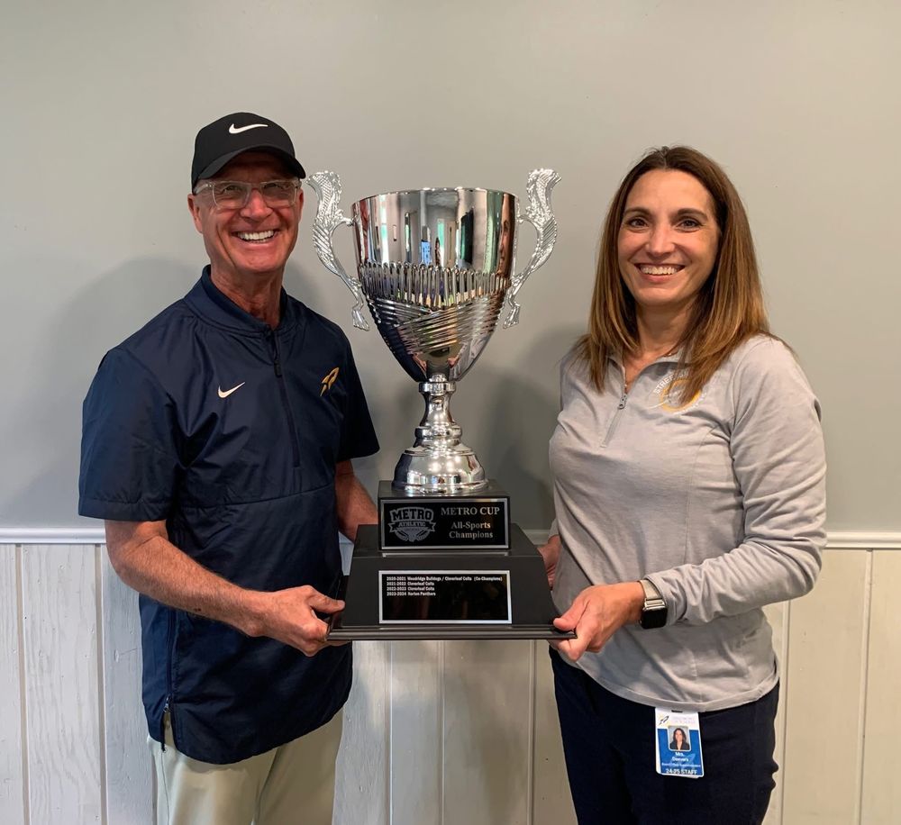 Athletic Director and Superintendent holding MAC trophy