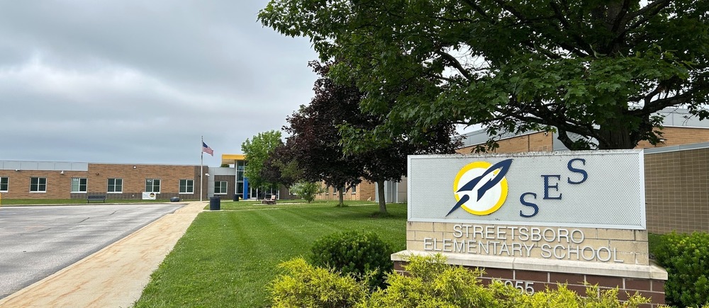 Photo of the exterior of streetsboro elementary school. With the sign featuring the name of the school and the logo in the foreground.