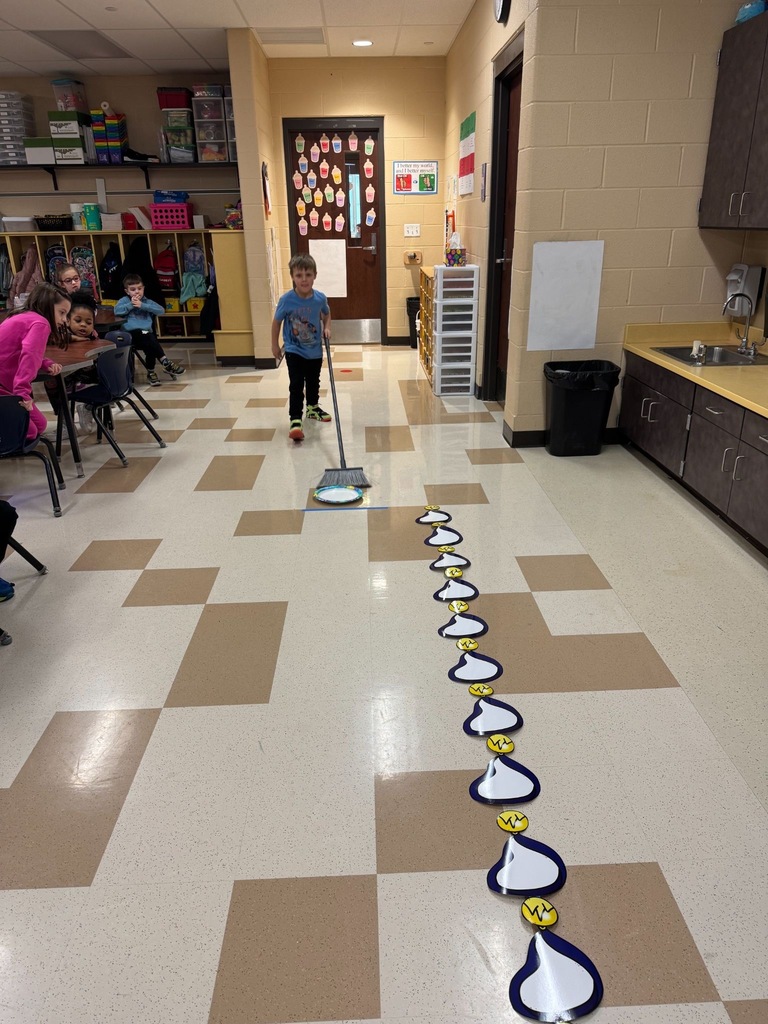 Students playing olympics games in a classroom. 