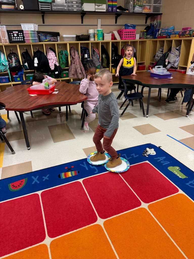 Students playing olympics games in a classroom. 