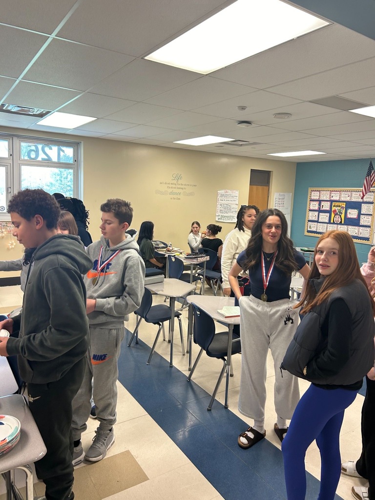 Students in a classroom talking to each other. 