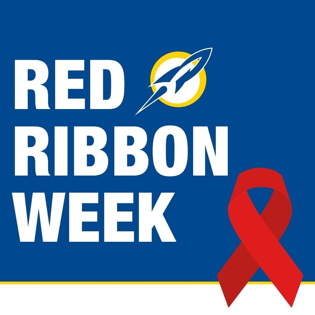 lue graphic reading "Red Ribbon Week," with a red awareness ribbon and a rocket logo.lue graphic reading "Red Ribbon Week," with a red awareness ribbon and a rocket logo.