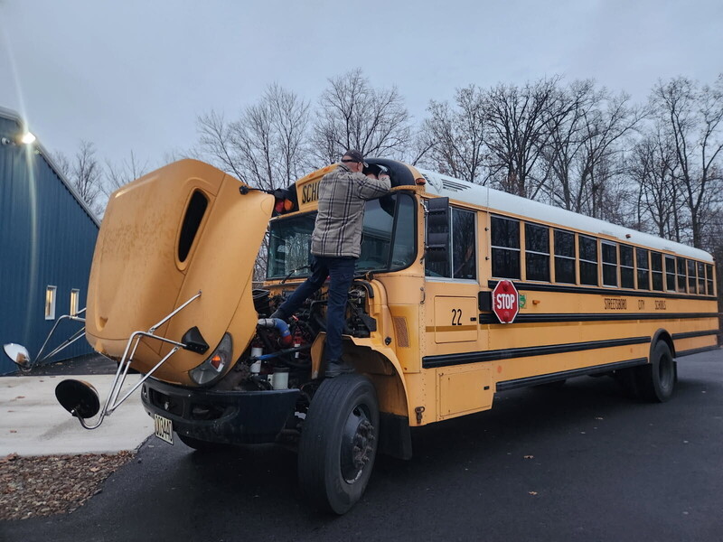 school bus being examined