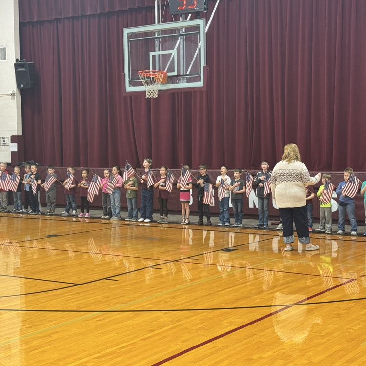 K-4 sing the anthem prior to tipoff.