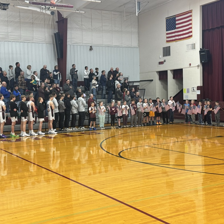 K-4 sing the anthem.