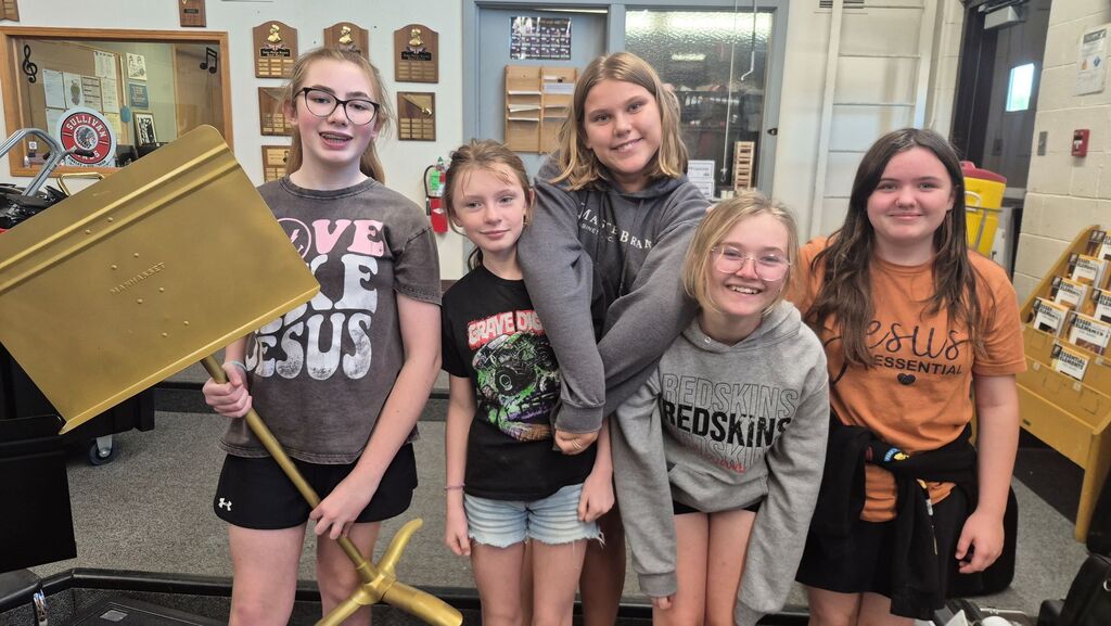 6th Grade Golden Stand recipient Madelyn Wilhelm and Section of the Week recipient Flute Section