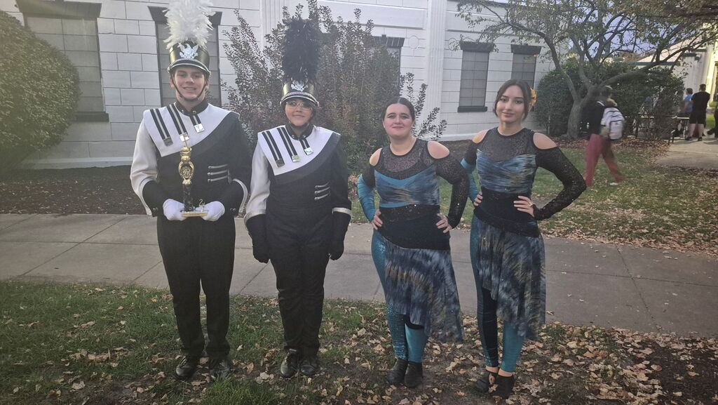 Drum Majors Gavin Wade and October Artrip as well as Guard members Anna Palmer and Claire Kursell after accepting the award for Second Place in Class 1A