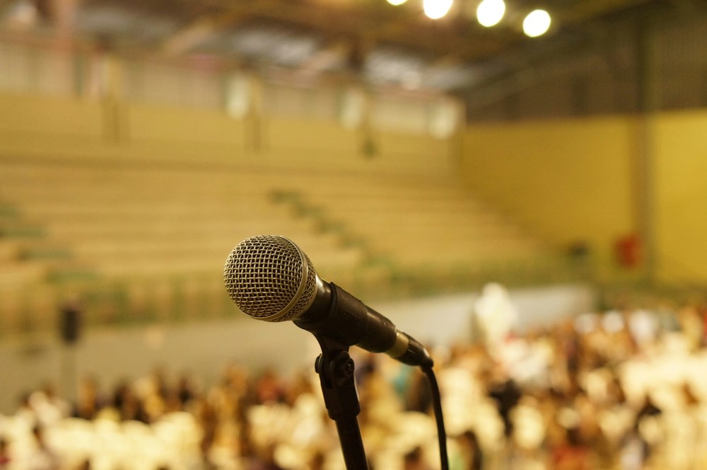 microphone in an auditorium filled with people