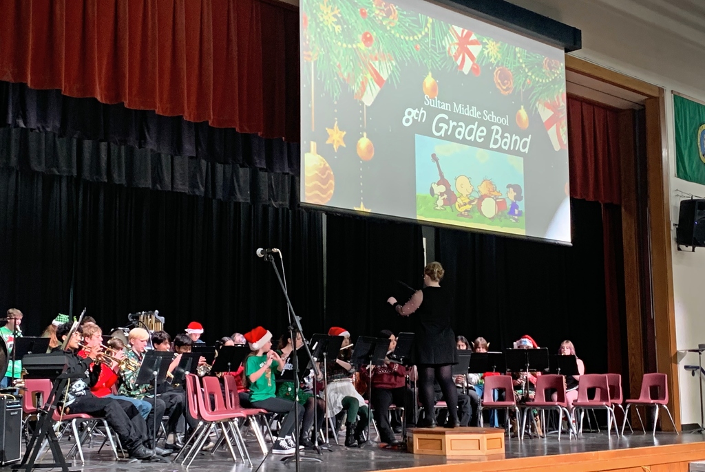 Band on stage playing instruments.