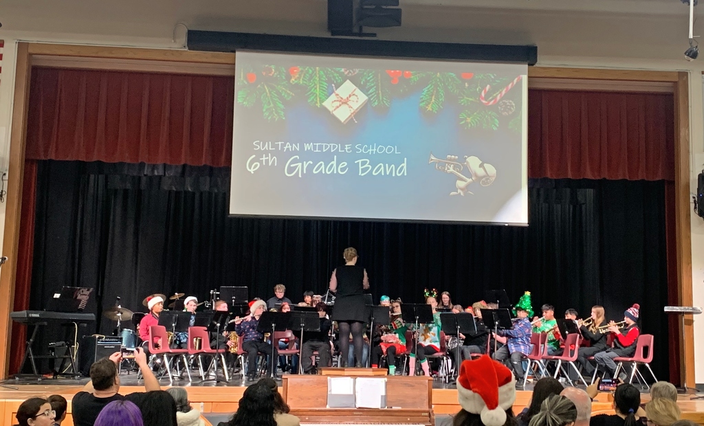 Band on stage playing instruments.