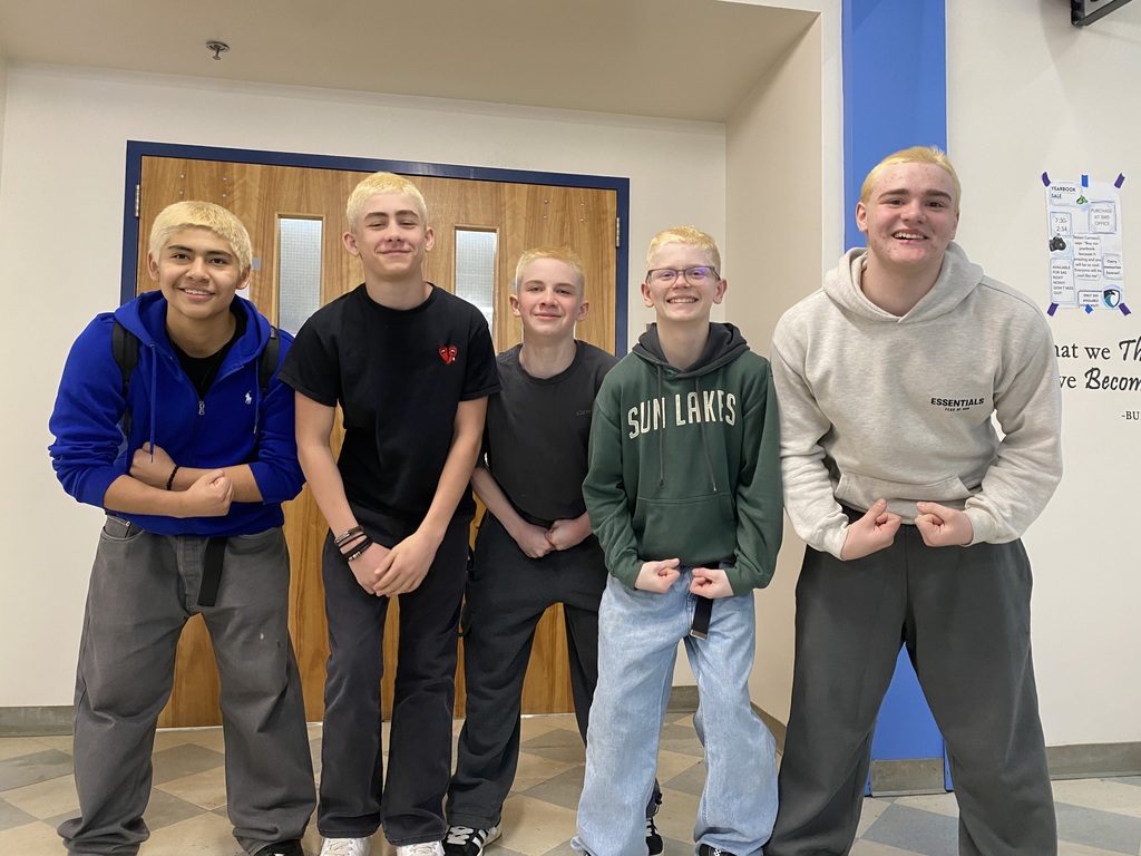 Boys with bleached hair flexing.