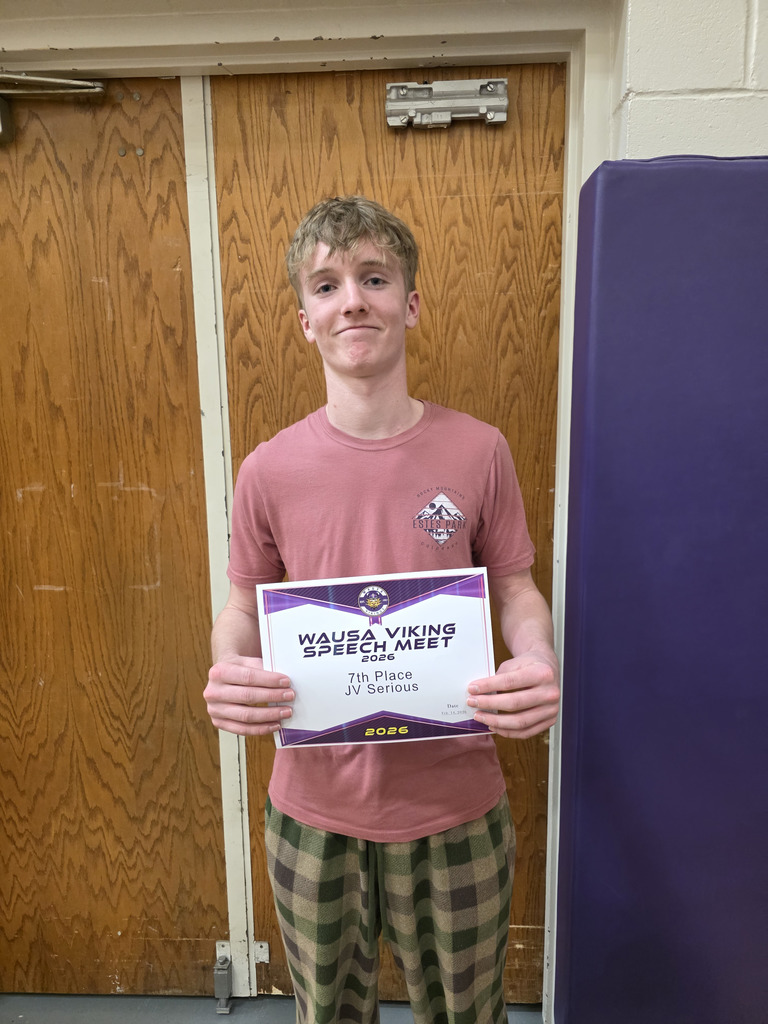 A boy holding up a 7th place certificate