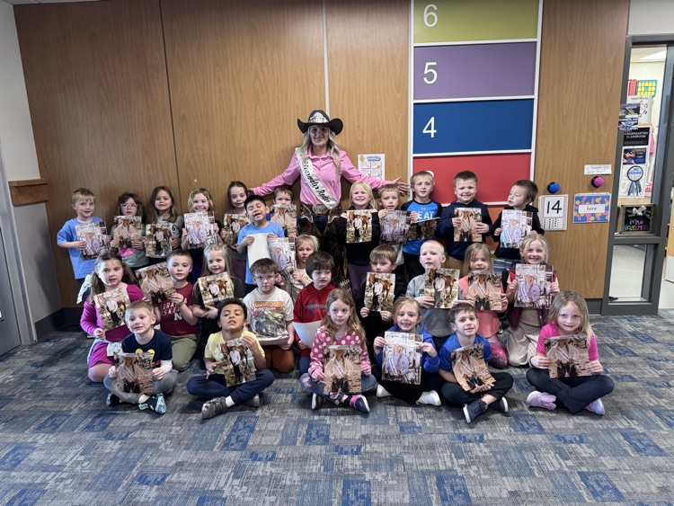 Kids with the Queen and their autographed pictures!