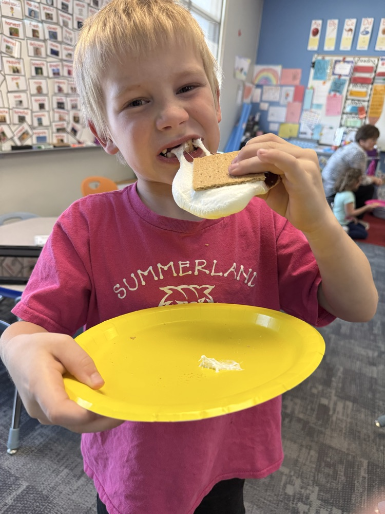 student eating a s’more