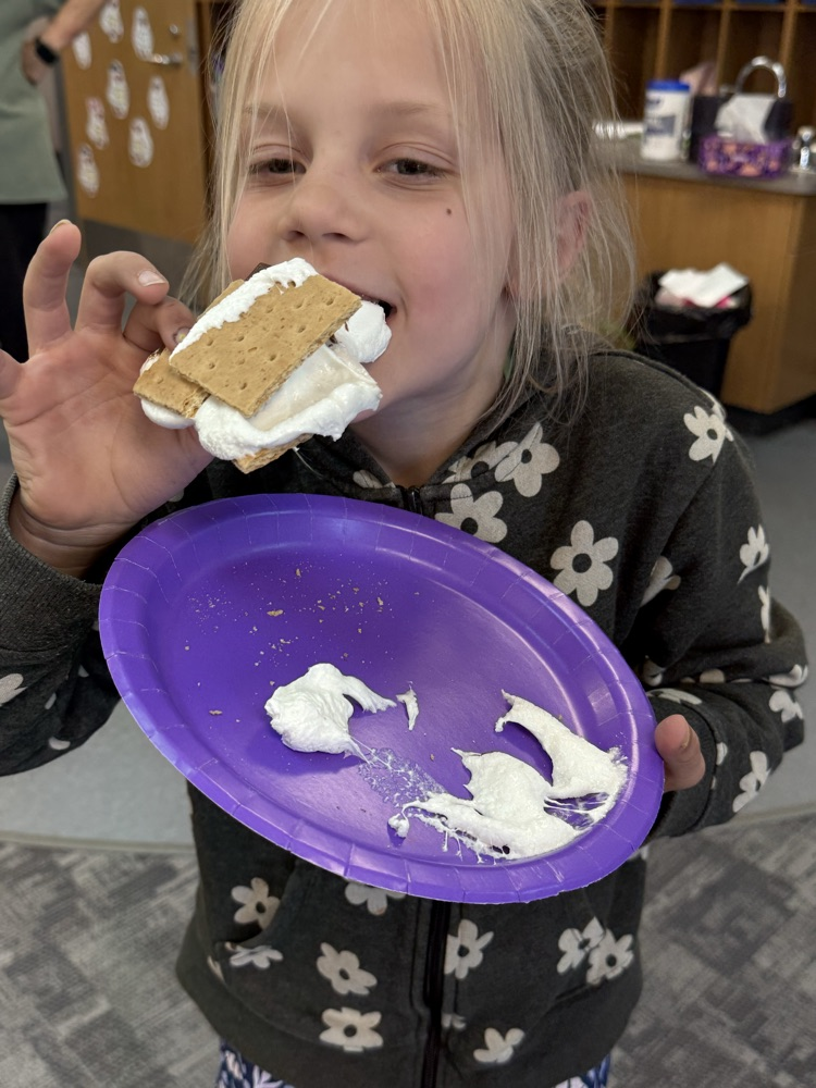 student eating a s’more
