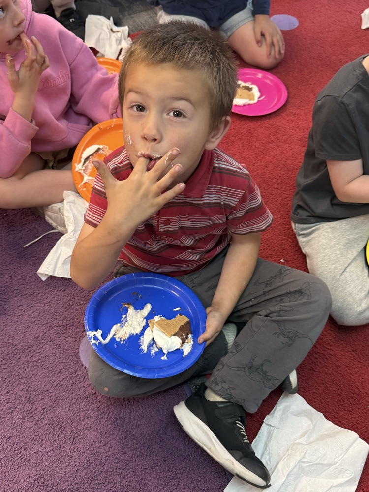 student eating a s’more