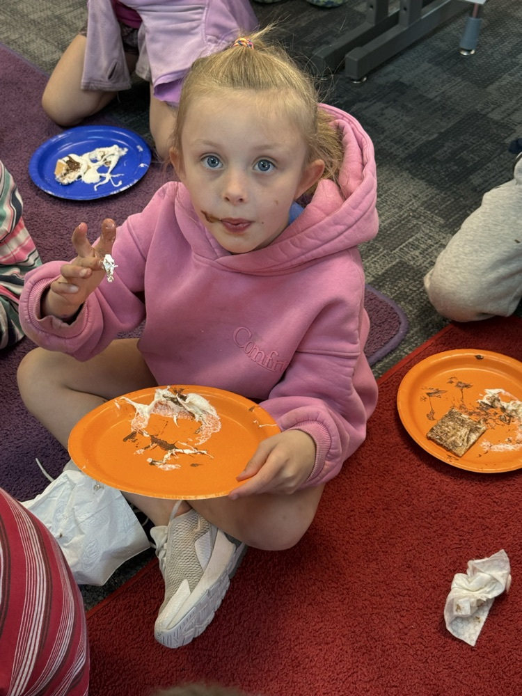 student eating a s’more