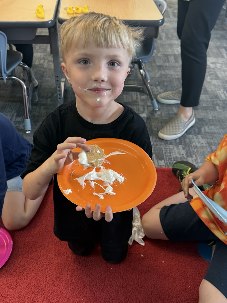 student eating a s’more