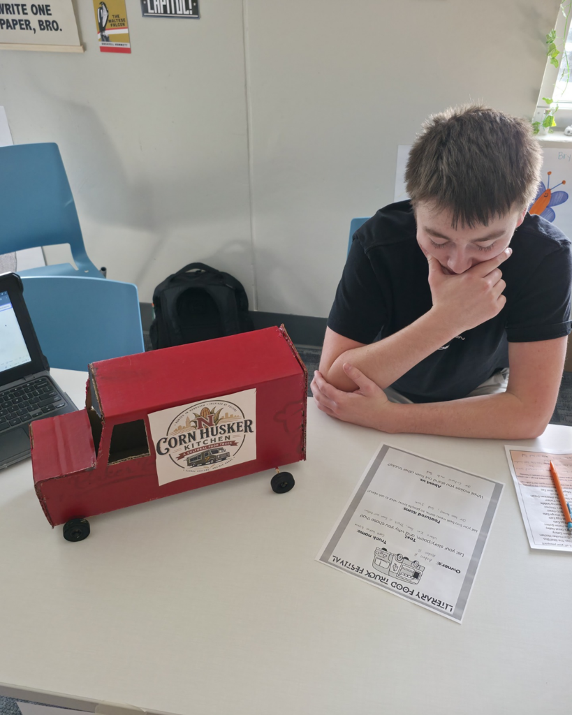 A teenage boy shares his red food truck called "Cornhusker Kitchen"