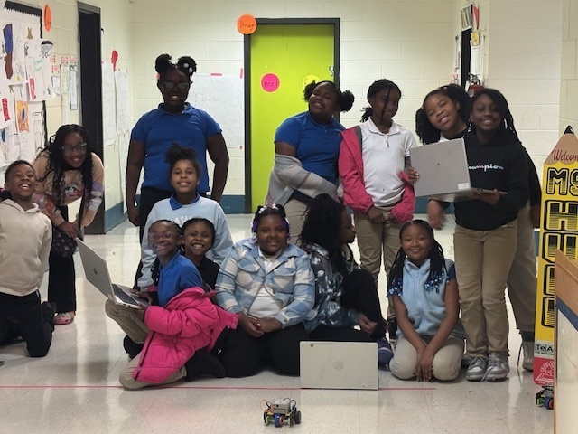 Ms. J. Jones 3rd and 4th grade STEM students with device.