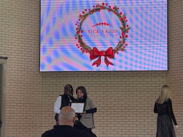 Ms. Huff receiving the Nick's Kids Award