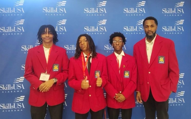 automotive teacher and students posing together