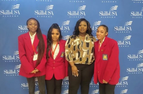 cosmetology students and teacher posing together 