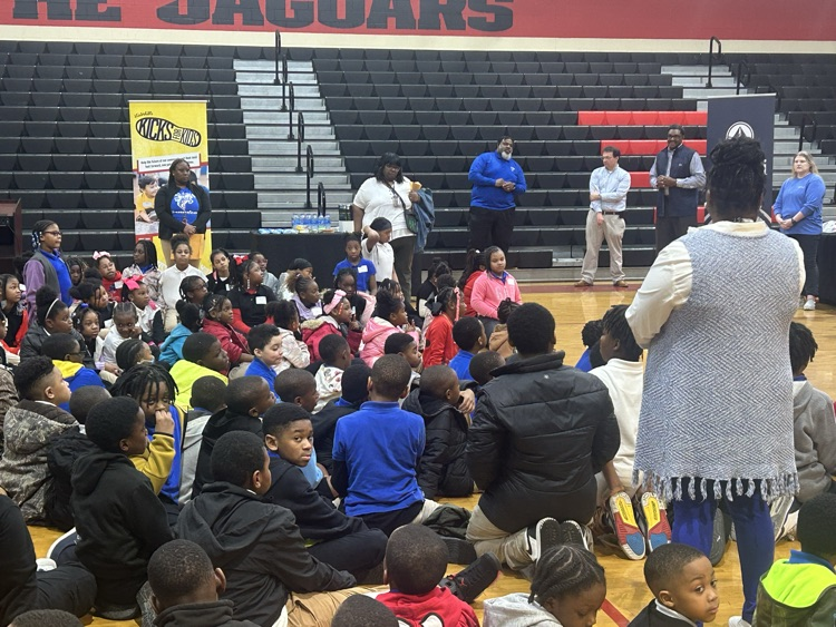 LJHS students seated on the floor waiting to get their shoes