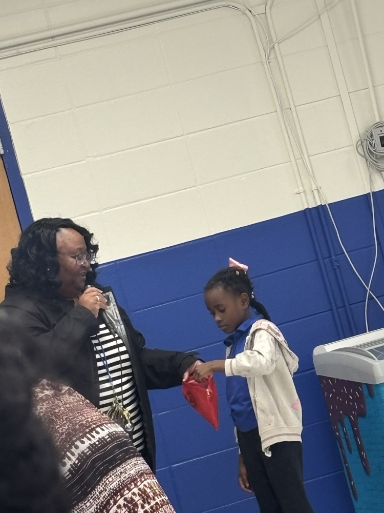 One of our kindergarten scholars, assisted in the attendance drawing.