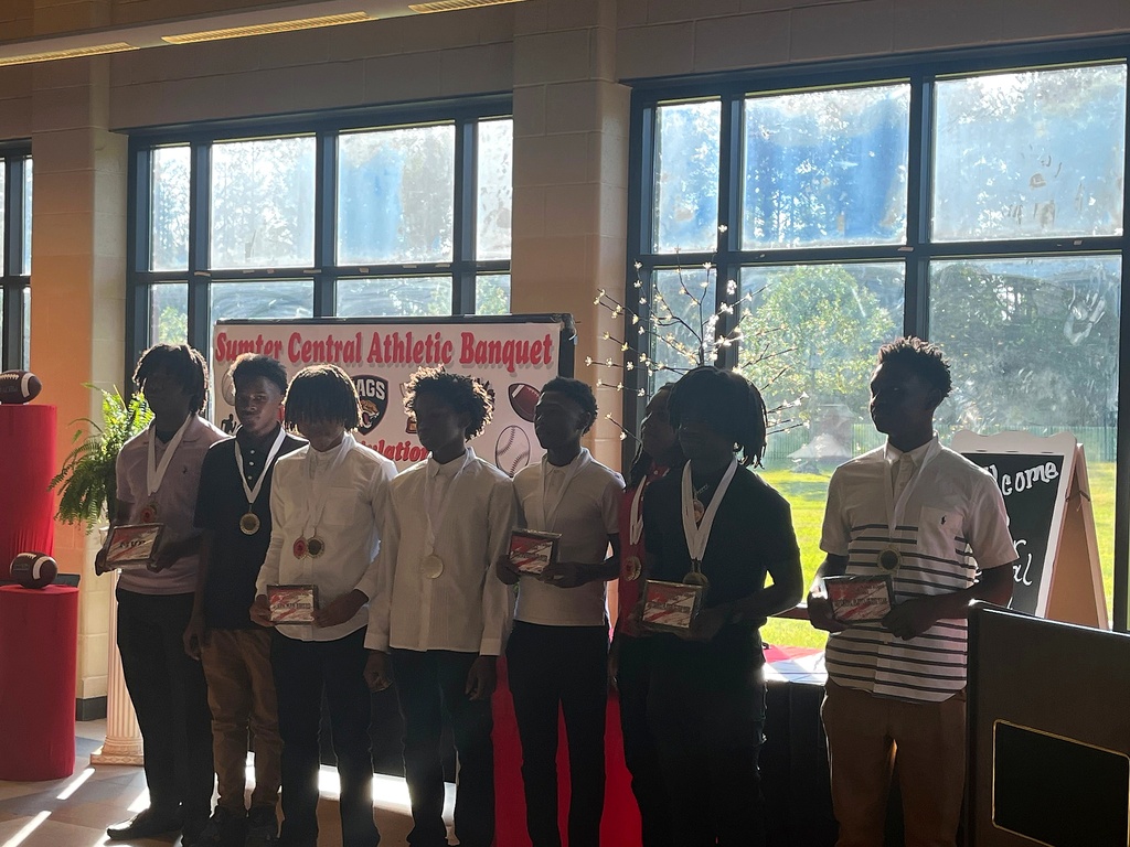 A series of photos from the Sumter Central High School Athletic Banquet held on May 4. Student-athletes stand in groups inside a decorated banquet hall while receiving awards, medals, plaques, and certificates for their athletic achievements. Coaches and presenters speak from a podium as students pose for recognition photos. Decorations include red and black table coverings, sports-themed displays, footballs, banners reading “Sumter Central Athletic Banquet,” and lighted decorative trees. The event celebrates student-athletes from multiple sports programs at Sumter Central High School.