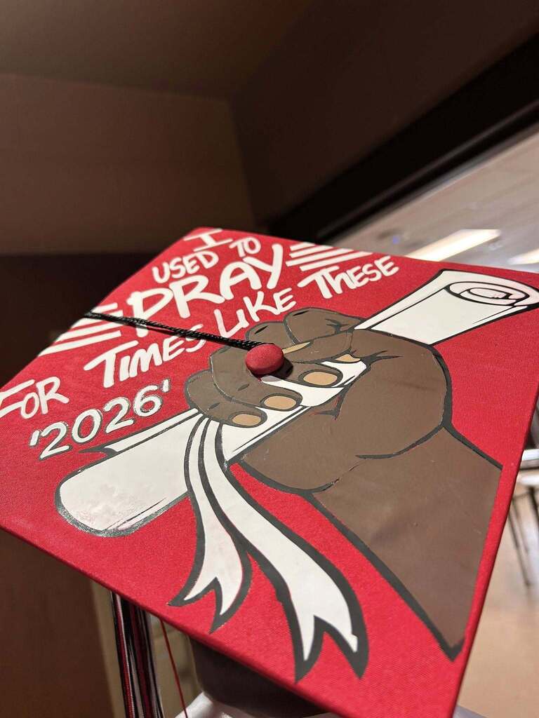 A red graduation cap with the writing I Used to pray for times like these 2026.