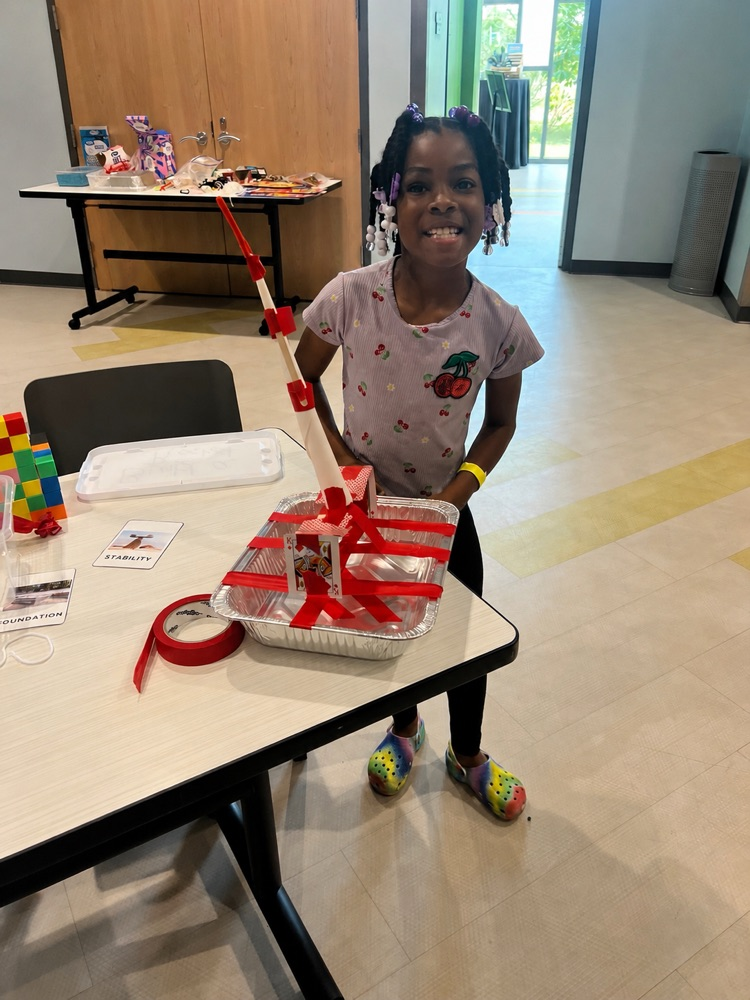 student standing near something she created