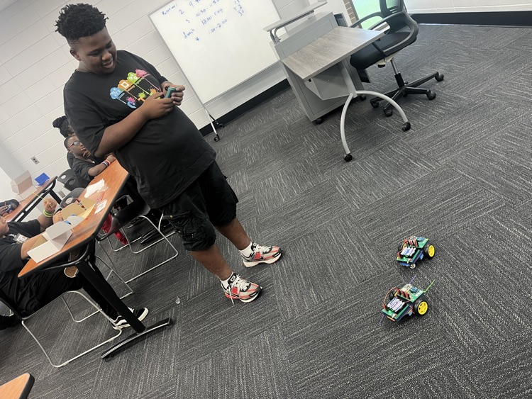student playing with robot