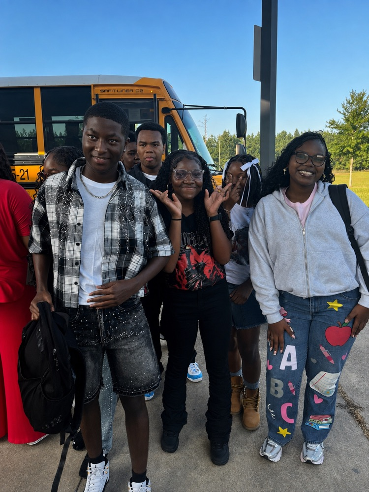 students getting off the bus