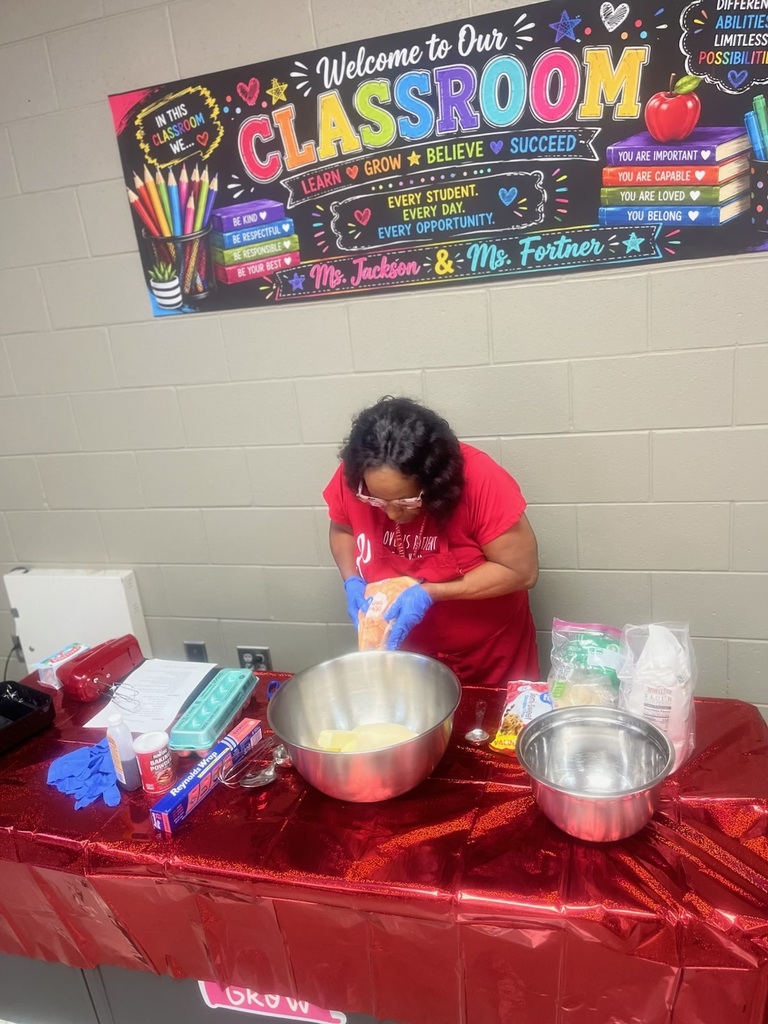 Teacher demonstrating how to measure for baking cookies
