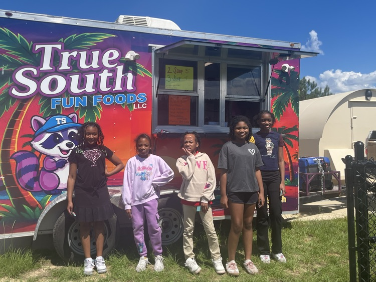 picture of students in front of snow cone truck