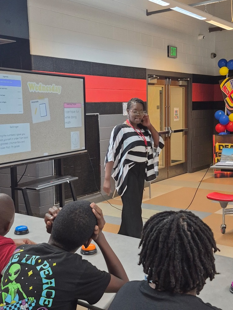 Mrs. Tolliver standing and presenting